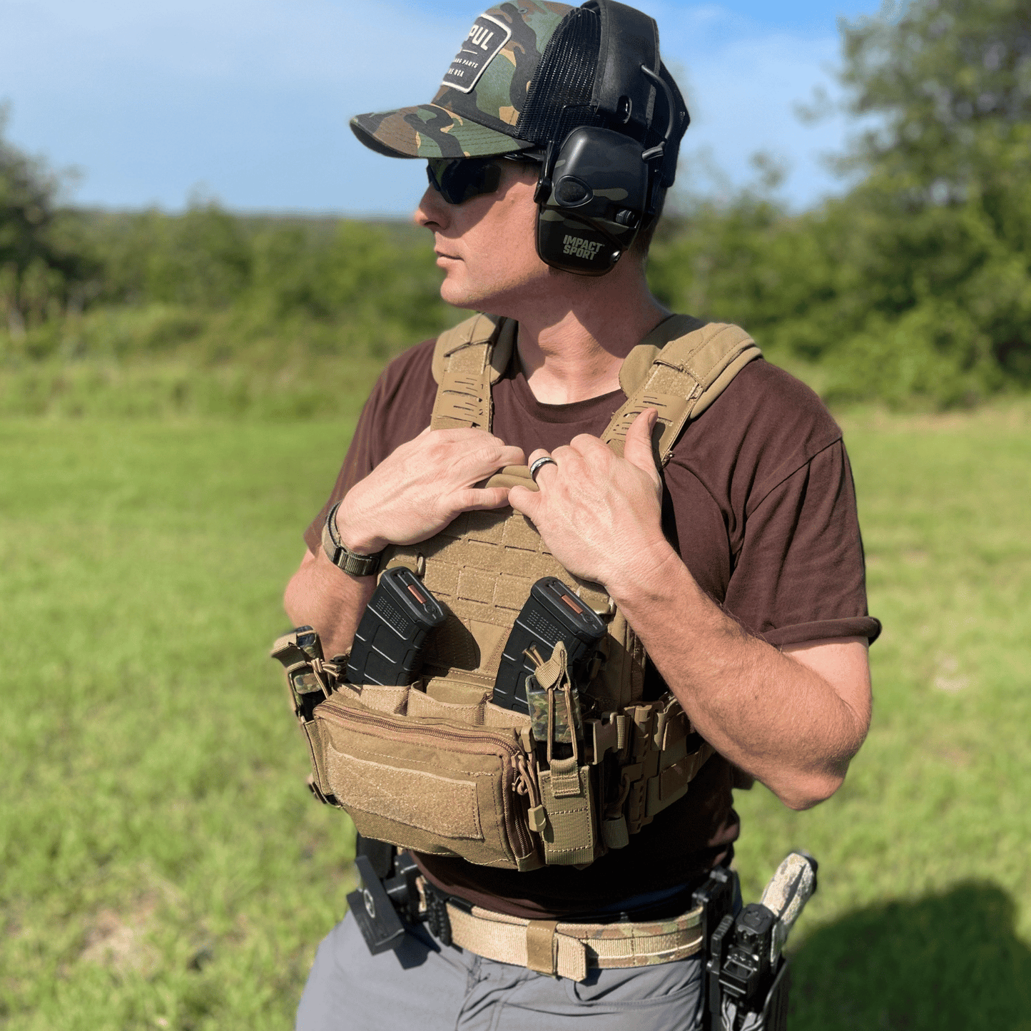 Person wearing tactical gear in an outdoor setting