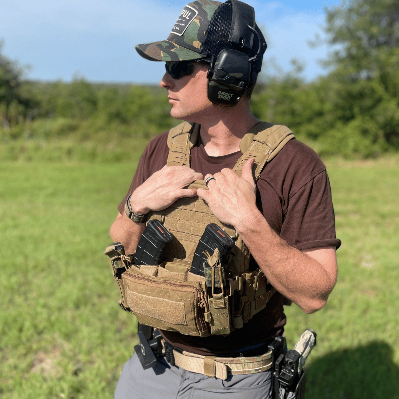 Person wearing tactical gear in an outdoor setting