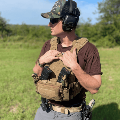 Person wearing tactical gear in an outdoor setting