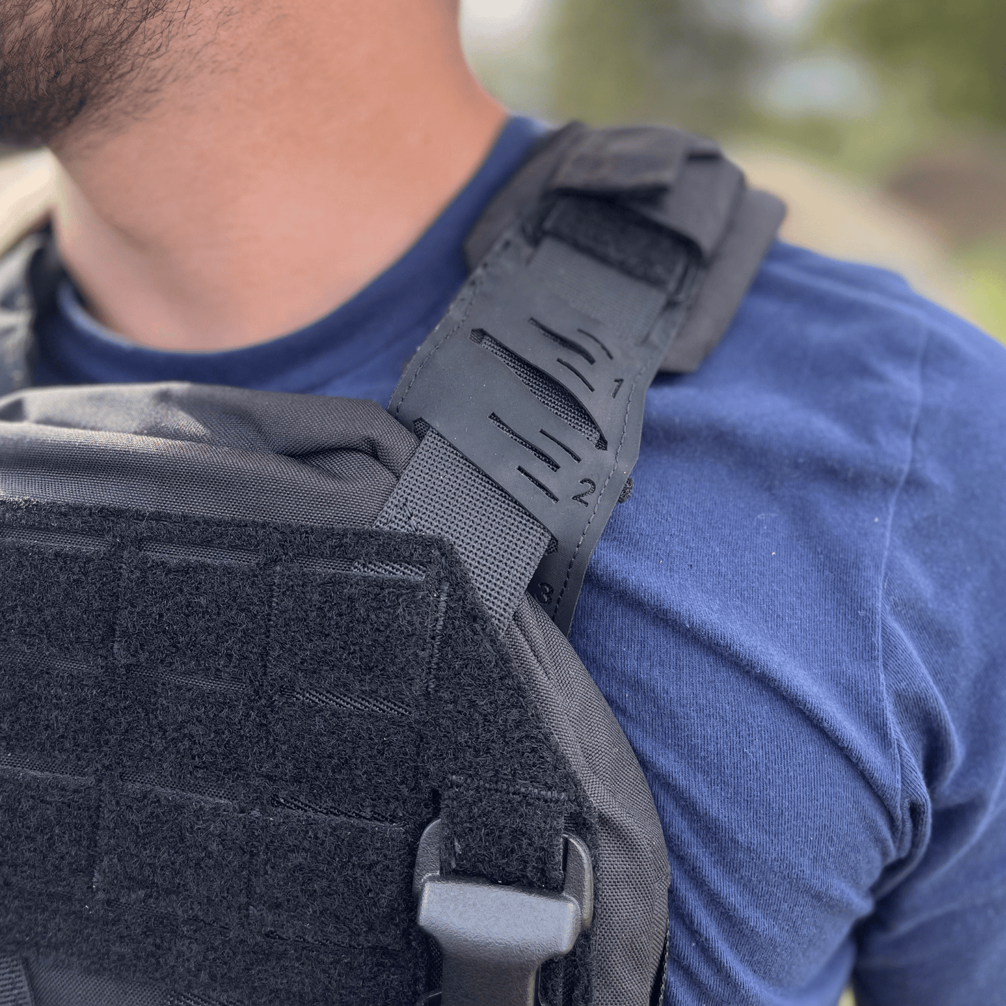 Close up showing stitching and detail of black plate carrier straps.